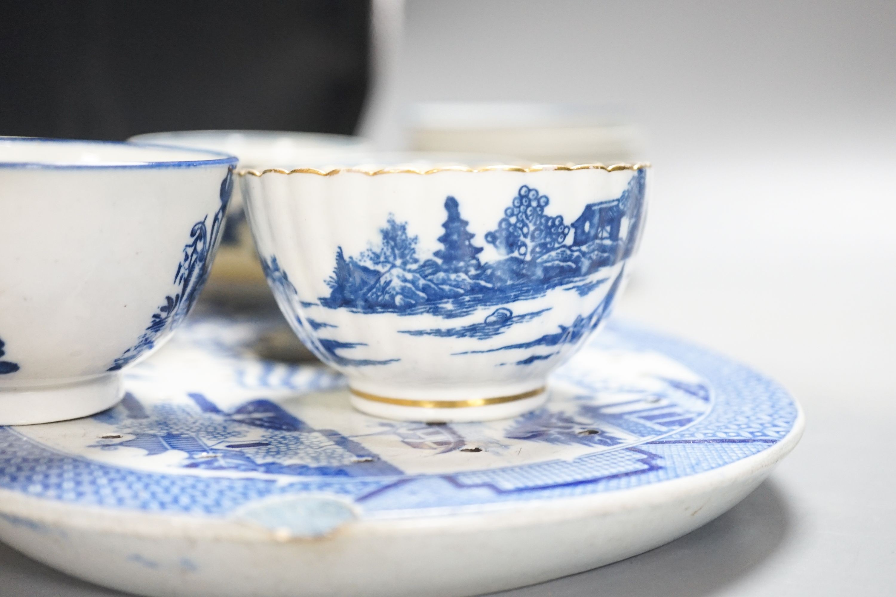 A group of Worcester and Caughley blue and white tea and coffee wares, late 18th century including fisherman pattern, three flowers pattern, chinoiserie figures etc.